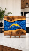 Walnut board with blue resin river and bolt crest