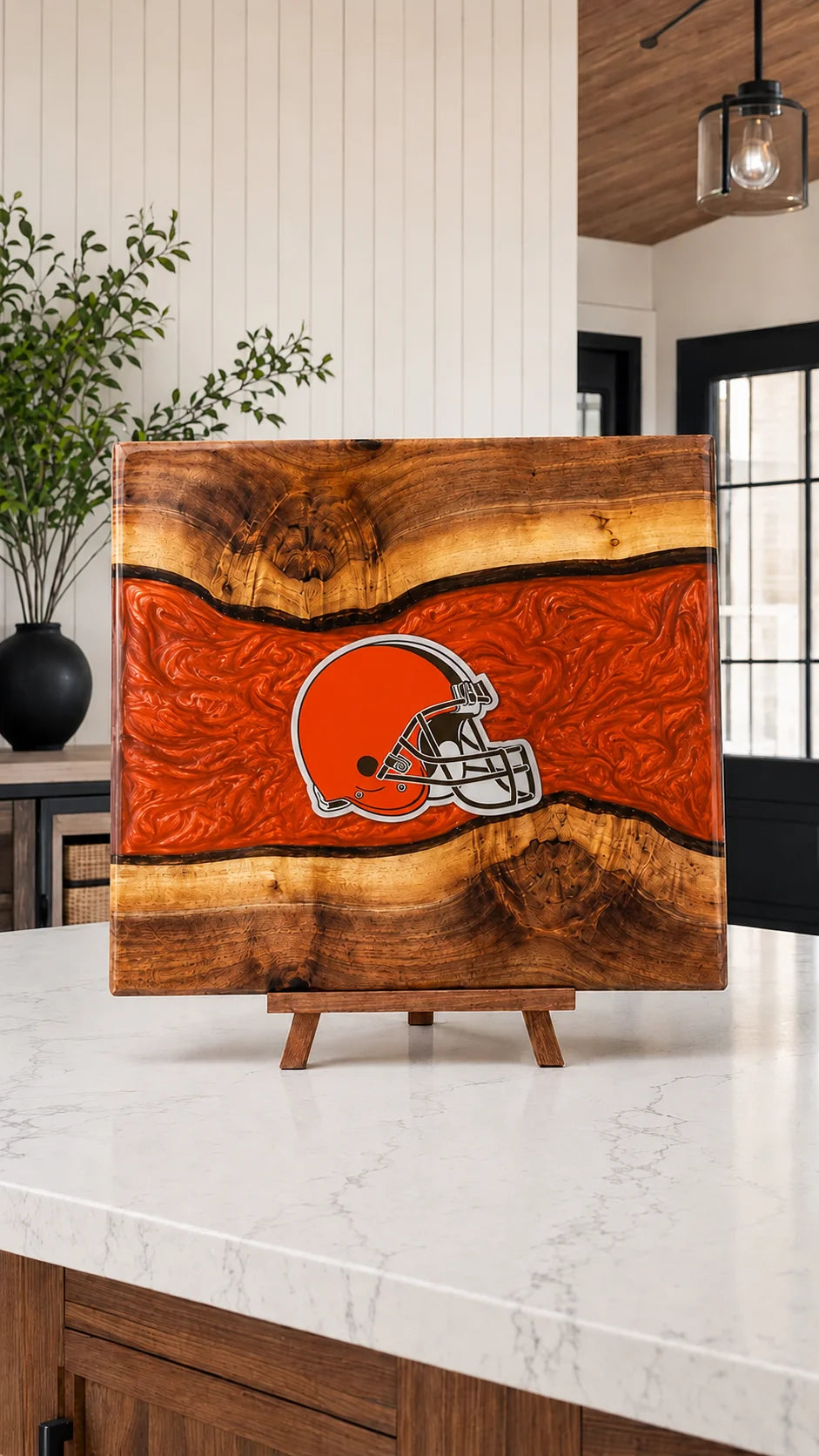 Walnut board with orange resin river and engraved helmet emblem